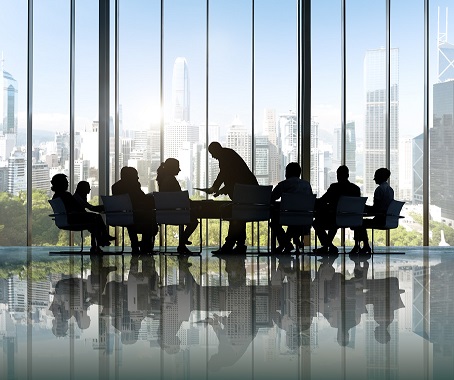 people gathered around a table for a meeting