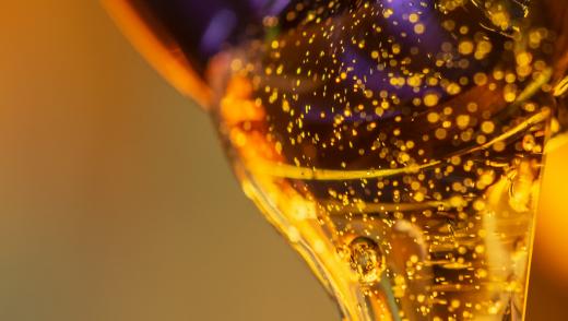 Golden liquid poured from a jar