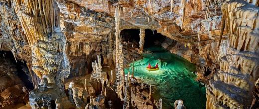 mage of a cave with stalactites and stalagmites and an underground waterhole